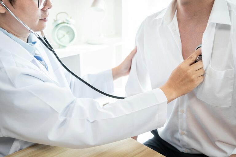 Doctor listening patient heartbeat with a stethoscope to diagnose heart rate examination